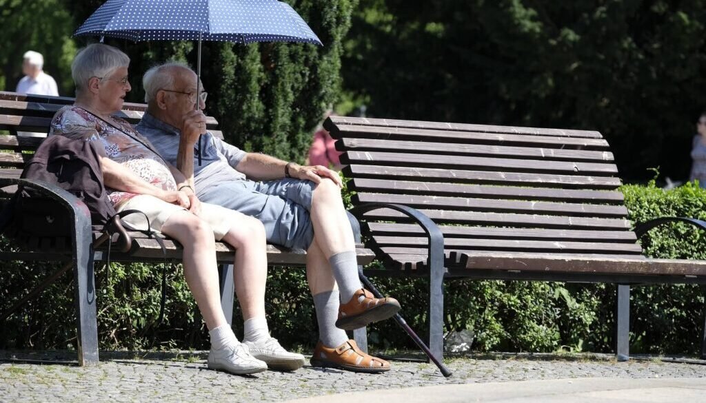 Elderly couple sitting on a park bench