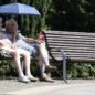 Elderly couple sitting on a park bench Elderly couple sitting on a park bench