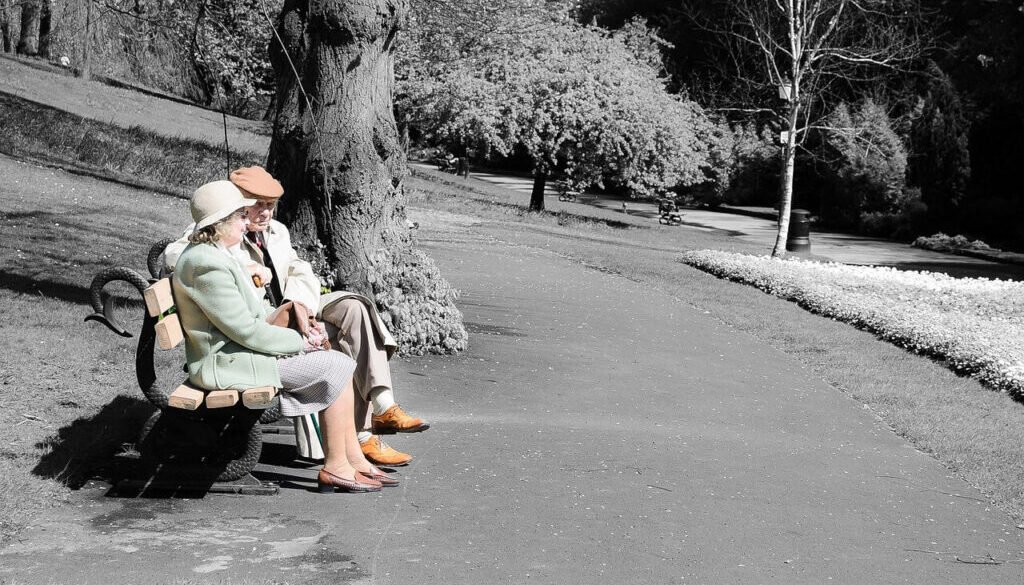 Elderly couple sitting on a park bench