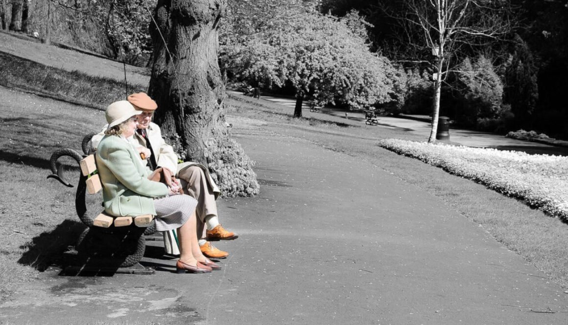 Elderly couple sitting on a park bench